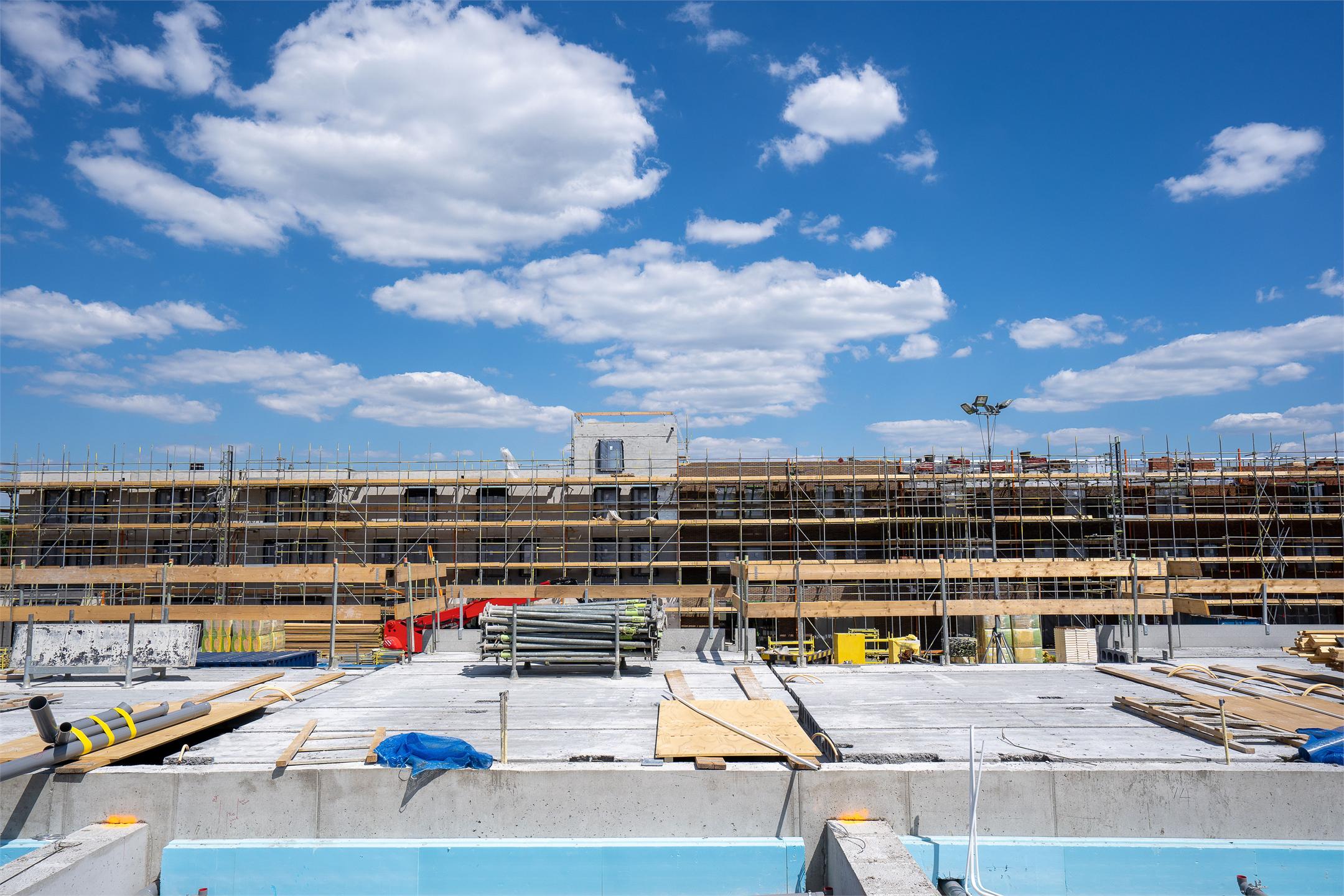 Construction site with multilevel scaffolding and building materials
